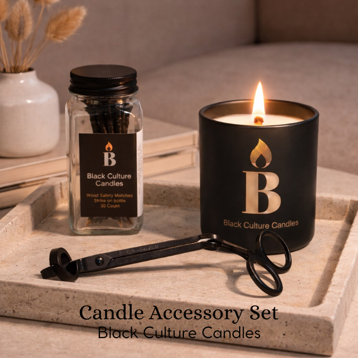 Black Culture Candles candle accessory set with wood safety matches in a glass jar and black metal wick trimmer on a marble tray.