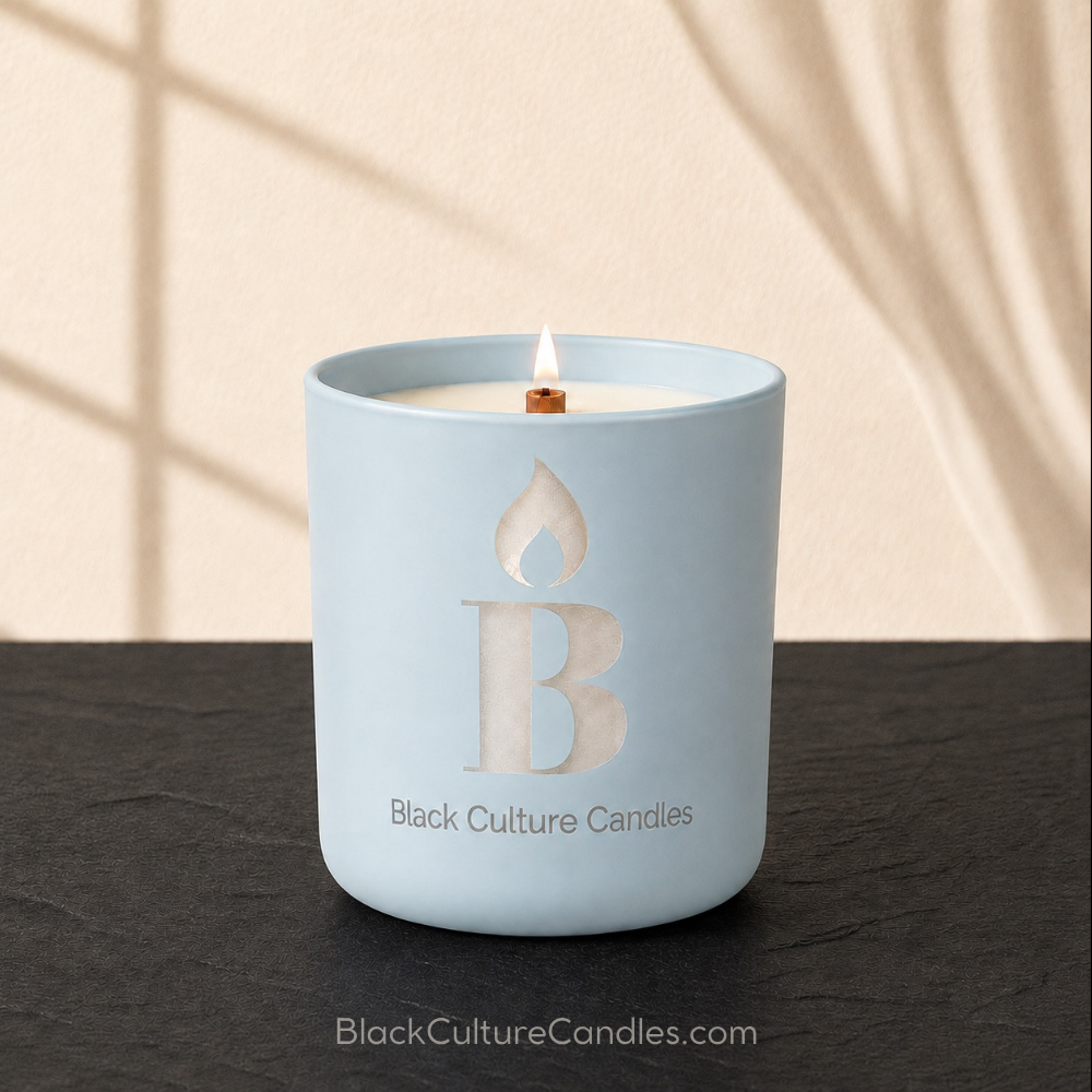 Cleaning Day candle by Black Culture Candles. Matte powder blue, etched glass jar on black slate with beige shadowed background.