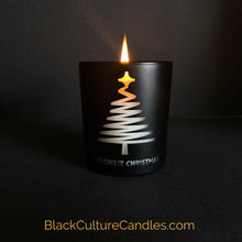Load image into Gallery viewer, Moonlit Christmas is a limited edition candle in a matte black jar with a modern pine tree engraving. The candle is partially burned, revealing a warm and inviting glow, casting a cozy atmosphere. The label on the jar prominently displays the Black Culture Candles logo. BlackCultureCandles.com
