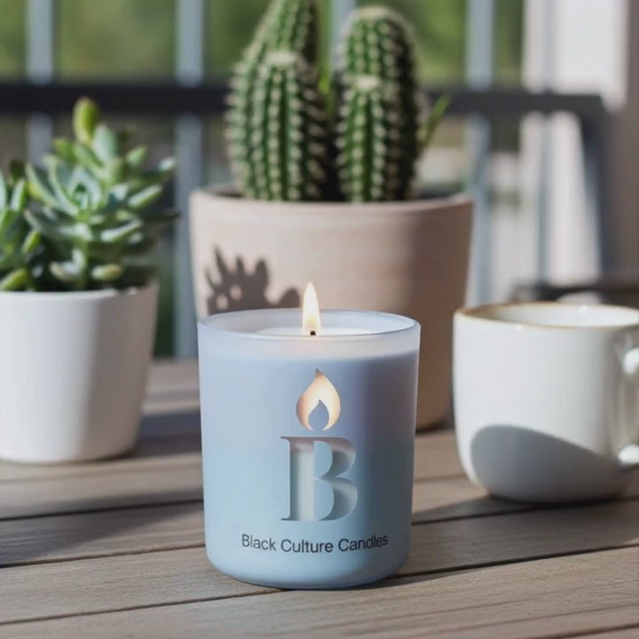 Cleaning Day candle by Black Culture Candles burning in an etched glass vessel with a crackling wood wick.